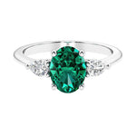 Three stone oval and pear shaped real green emerald and diamond ring in classic design.