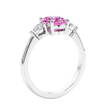 Oval cut three stone real pink sapphire, a pink diamond ring alternative, and diamond engagement ring with romantic charm.