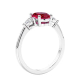 Oval cut three stone real red ruby and diamond engagement ring with romantic charm.
