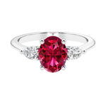 Three stone oval and pear shaped real red ruby and diamond ring in classic design.