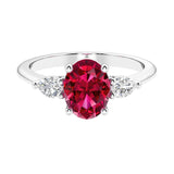 Three stone oval and pear shaped real red ruby and diamond ring in classic design.
