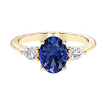 Oval and pear shape 3 stone engagement ring with blue sapphire and brilliant diamond side stones.