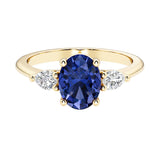 Oval and pear shape 3 stone engagement ring with blue sapphire and brilliant diamond side stones.