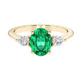 Oval and pear shape 3 stone engagement ring with colombian emerald and brilliant diamond side stones.