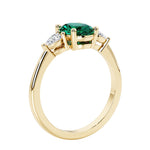 3 stone wedding ring with oval center gemstone and pear shape diamond side stones.