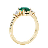 3 stone wedding ring with oval center gemstone and pear shape diamond side stones.