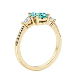 3 stone wedding ring with oval center gemstone and pear shape diamond side stones.