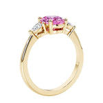 3 stone wedding ring with oval center gemstone and pear shape diamond side stones.