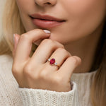 Elegant woman wearing oval shaped 3 stone engagement ring with soft sparkle.