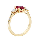 3 stone wedding ring with oval center gemstone and pear shape diamond side stones.