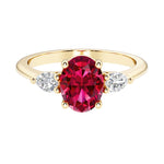 Oval and pear shape 3 stone engagement ring with red ruby and brilliant diamond side stones.