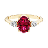 Oval and pear shape 3 stone engagement ring with red ruby and brilliant diamond side stones.