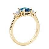 3 stone oval engagement ring with elegant proportions with alexandrite gemstone and diamond side stones.