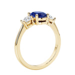 3 stone oval engagement ring with elegant proportions with blue sapphire gemstone and diamond side stones.