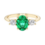 Oval 3 stone engagement ring with real colombian emerald and brilliant diamond side stones.