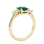 3 stone oval engagement ring with elegant proportions with emerald gemstone and diamond side stones.