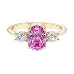 Oval 3 stone engagement ring with real pink sapphire and brilliant diamond side stones.