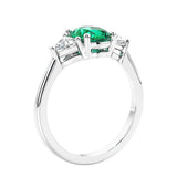 3 stone oval ring with green gemstone and diamonds in sleek white gold.