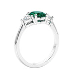 3 stone oval ring with green gemstone and diamonds in sleek white gold.