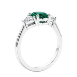 3 stone oval ring with green gemstone and diamonds in sleek white gold.