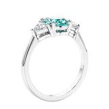 3 stone oval ring with green gemstone and diamonds in sleek white gold.