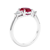 3 stone oval ring with red gemstone and diamonds in sleek white gold.