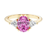 Oval cut three stone diamond engagement ring with romantic charm with pink gemstone center 14k yellow gold