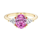 Oval cut three stone diamond engagement ring with romantic charm with pink gemstone center 14k yellow gold