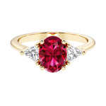Oval cut three stone diamond engagement ring with romantic charm with red gemstone center 14k yellow gold