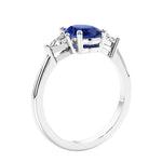 3 stone oval ring with gemstone and diamonds in sleek white gold.