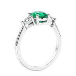 3 stone oval ring with gemstone and diamonds in sleek white gold.