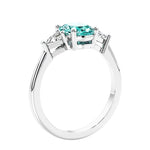 3 stone oval ring with gemstone and diamonds in sleek white gold.
