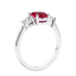 3 stone oval ring with gemstone and diamonds in sleek white gold.