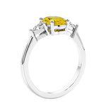 3 stone oval ring with gemstone and diamonds in sleek white gold.