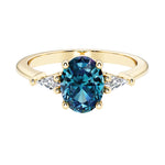 Oval cut three stone alexandrite engagement ring with diamonds set yellow gold.
