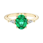 Oval cut three stone alexandrite engagement ring with diamonds set yellow gold.