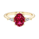Oval cut three stone ruby engagement ring with diamonds set yellow gold.