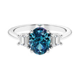 Oval cut three stone diamond engagement ring with romantic charm.