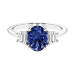 Oval cut three stone diamond engagement ring with romantic charm.