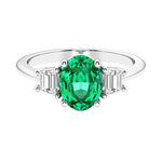 Oval cut three stone diamond engagement ring with romantic charm.