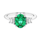 Oval cut three stone diamond engagement ring with romantic charm.