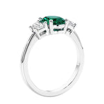 Engagement ring with oval shaped green gemstone and diamonds in a 3 stone design.