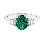 Oval cut three stone diamond engagement ring with romantic charm.