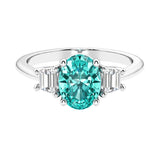 Oval cut three stone diamond engagement ring with romantic charm.
