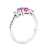 Engagement ring with oval shaped pink gemstone and diamonds in a 3 stone design.