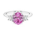 Oval cut three stone diamond engagement ring with romantic charm.