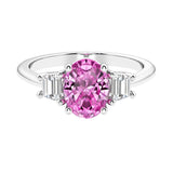 Oval cut three stone diamond engagement ring with romantic charm.