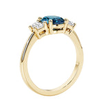 3 stone wedding ring with oval center gemstone and diamond side stones.