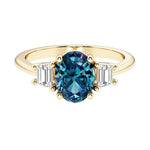 3 stone oval engagement ring with elegant proportions with gemstone and diamonds.