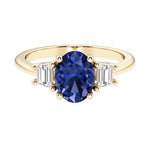 3 stone oval engagement ring with elegant proportions with blue gemstone and diamonds.